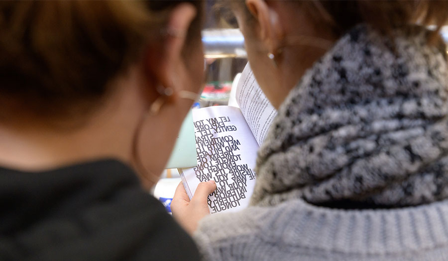 Two students reading text together