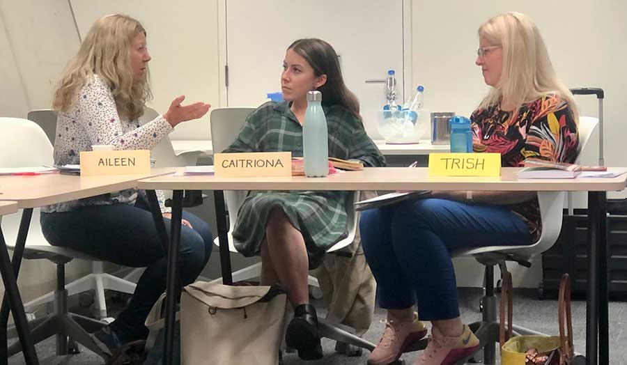 Three female students in discussion