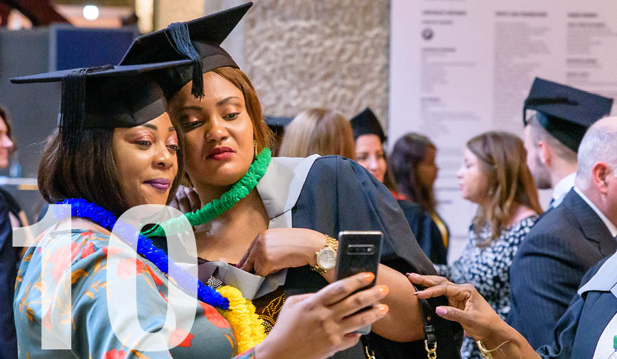 Graduating students looking at a photo