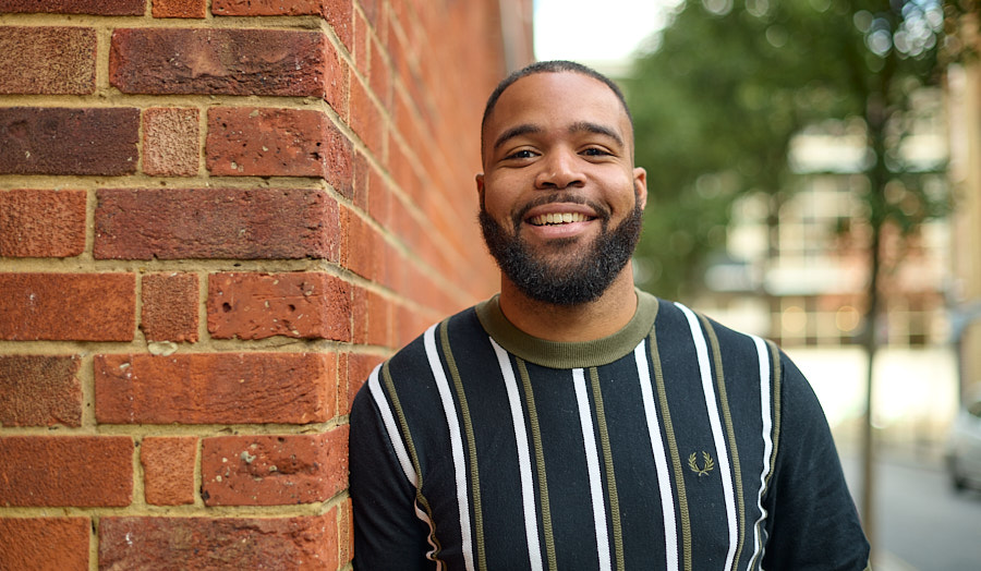 raymon standing outside against a wall