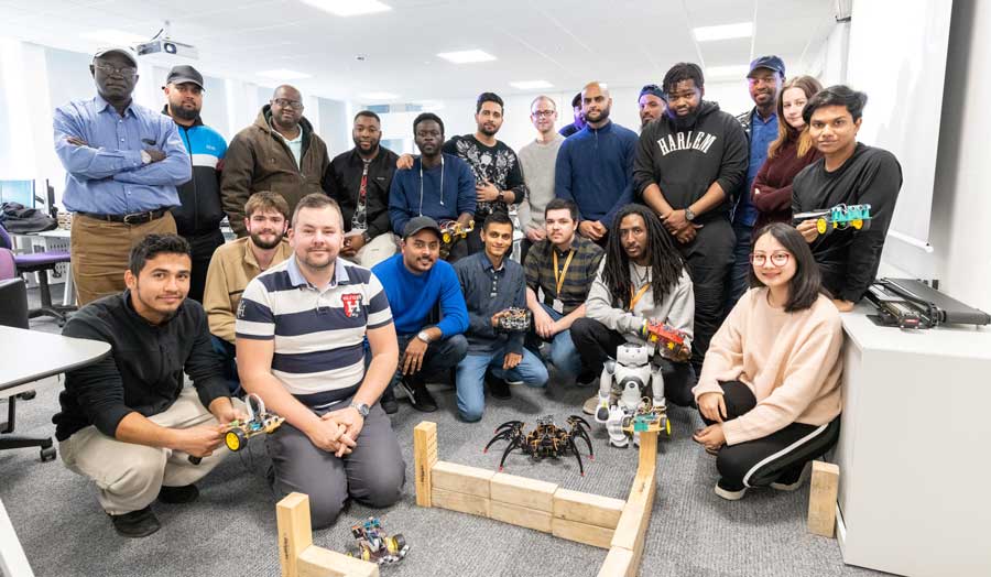 group of research and postgraduate students, 8 kneeling at the front, 14 standing behind