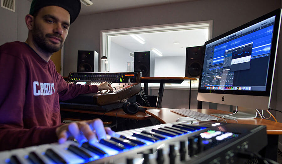 Student working in surround sound music studio