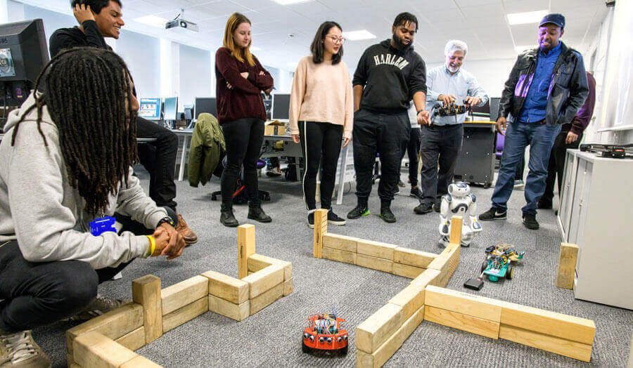 Students designing computer-connected systems with their tutor
