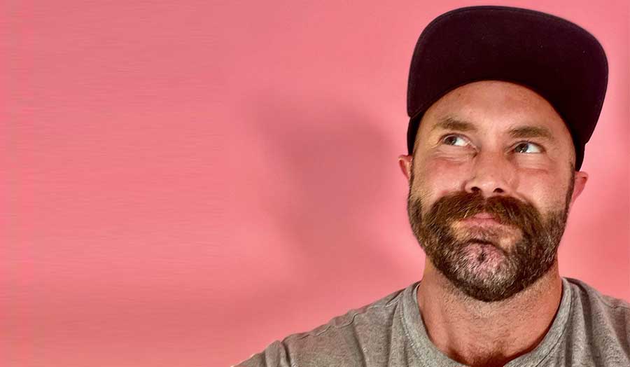 Chris Morriss-Roberts smiling and wearing a cap