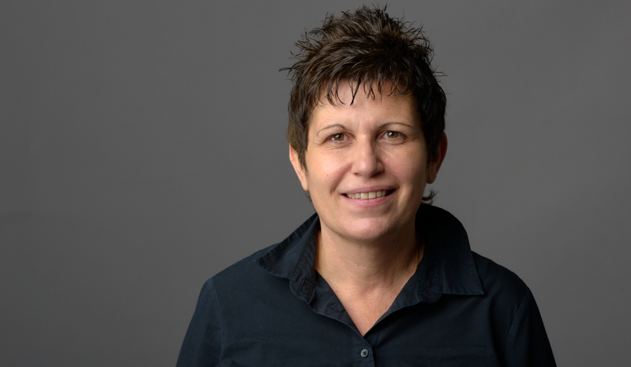Headshot of Dr Eleni Meletiadou on a grey background