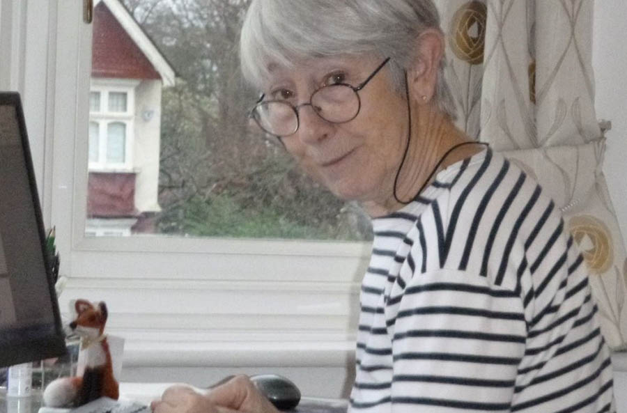 Profile of Julia Atkins sat at her desk