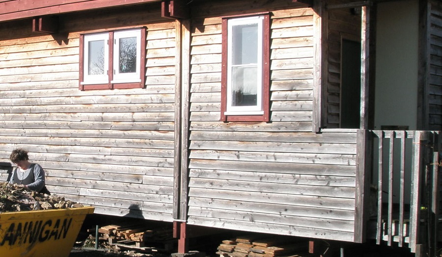 Mary Kelly, Architect next to wooden building