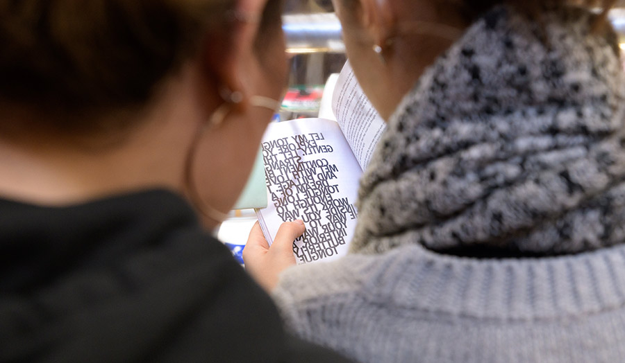 A photo of two young students taken from behind