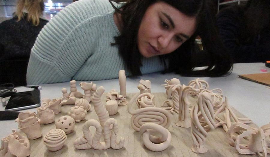 Student admires the mini sculptures