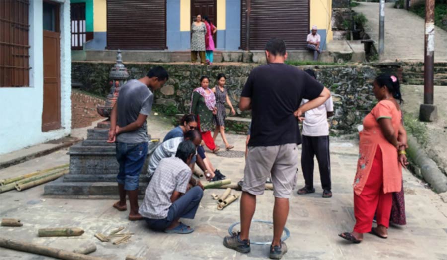 A group a people drawing on the floor.
