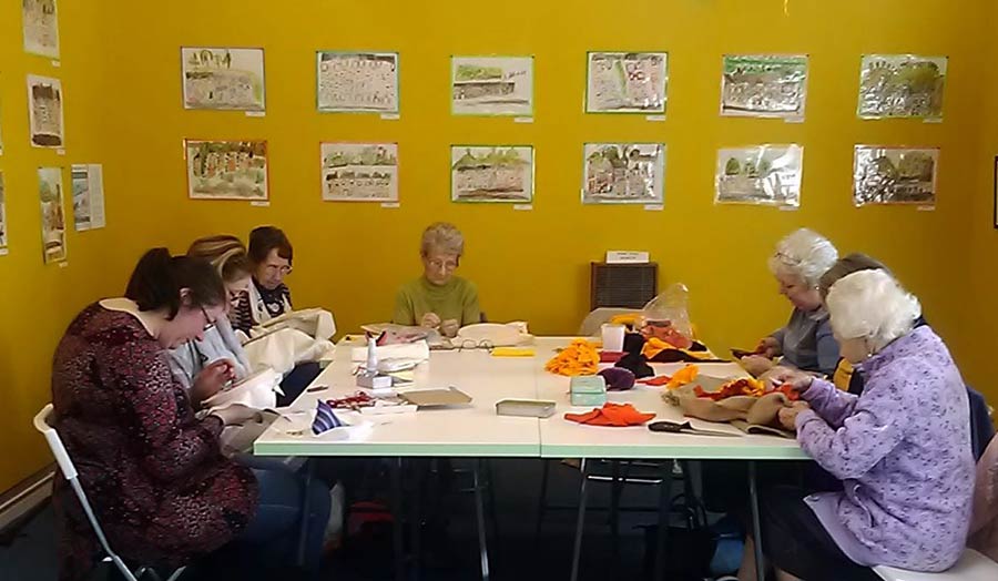 A group of women sewing around a table