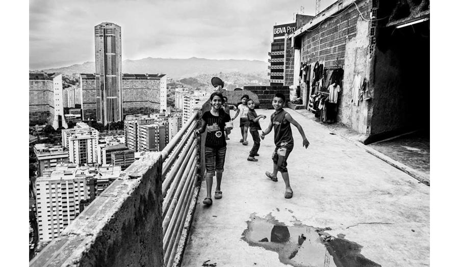 A group of children posing for the camera on the roof of a tower block