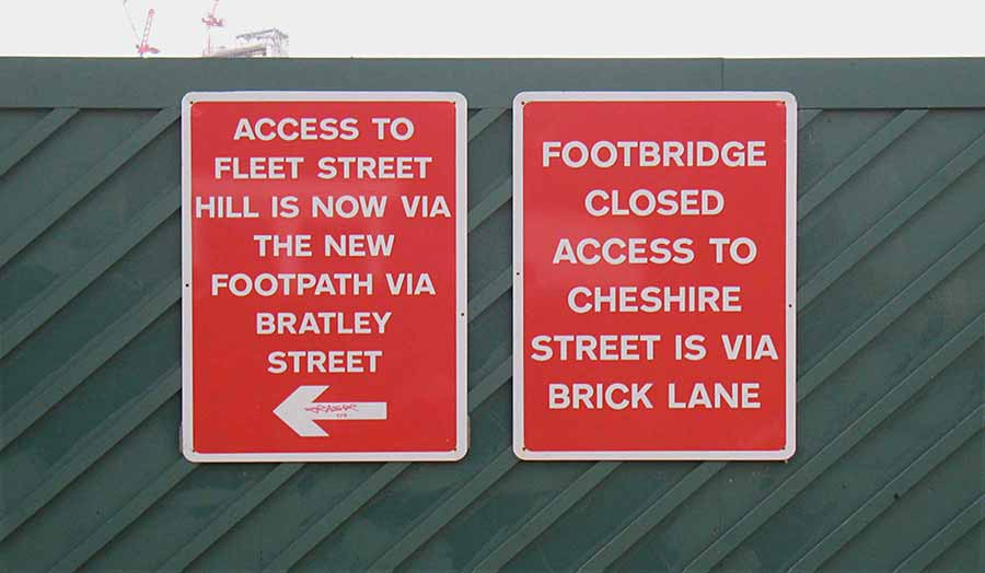 Red sign posts for directions