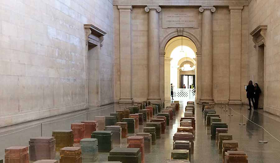 Installation of several resin coloured cubes aligned on the floor