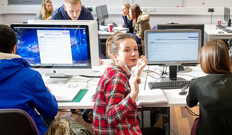 Close-up of students and computer screens