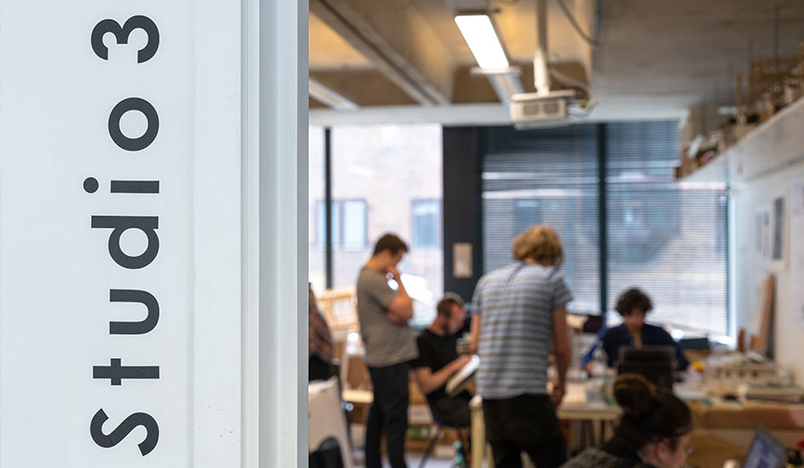 Studio 3 sign with architecture students and staff in background