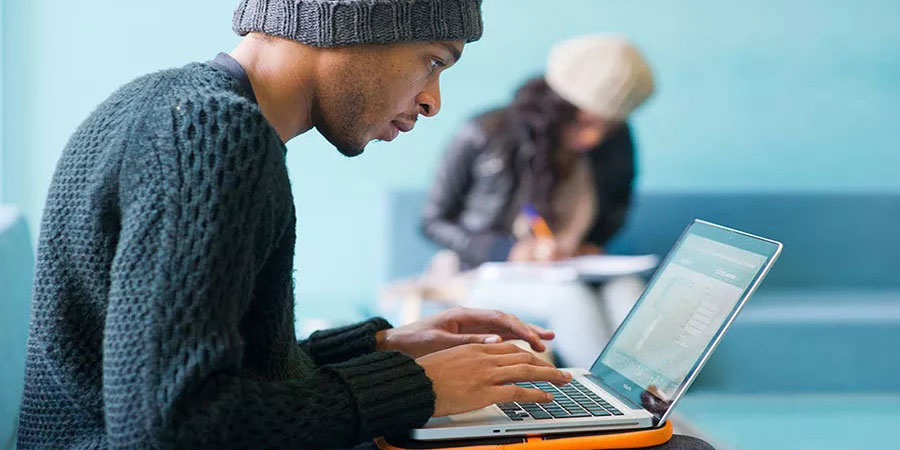 Student typing on a laptop
