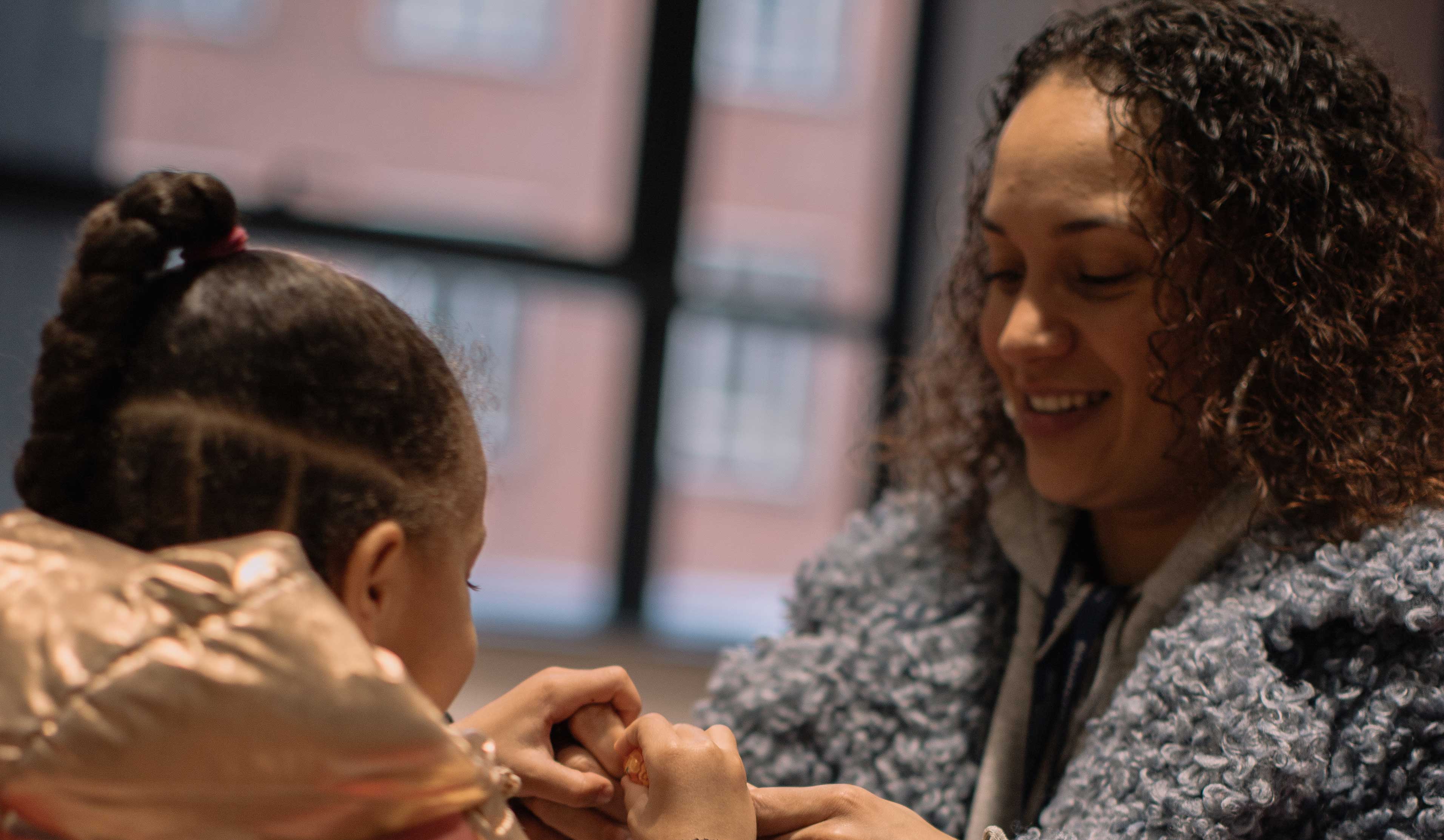 A student mum sitting with her daughter
