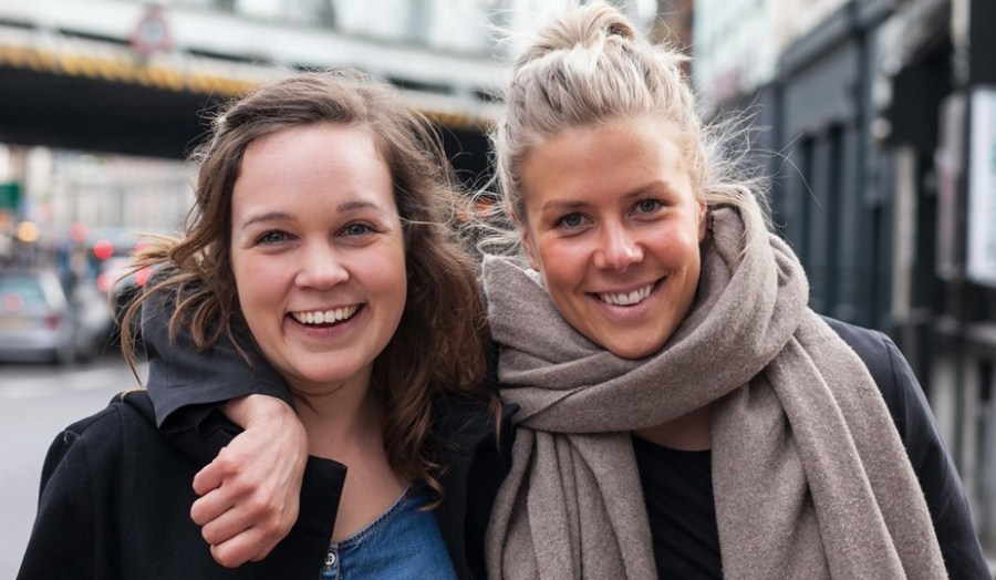 Anna Ojutkangas and Eveliina Suoyrjo smiling, closeup, looking happy