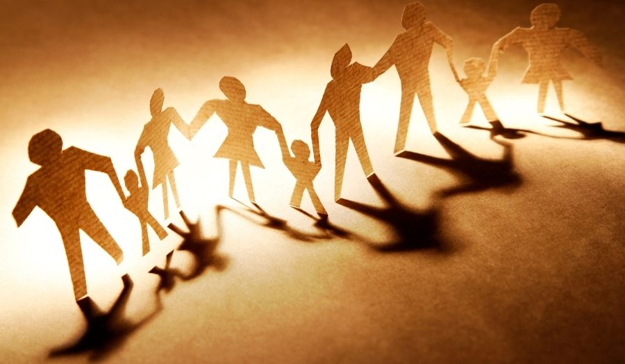 a row of paper figures holding hands 