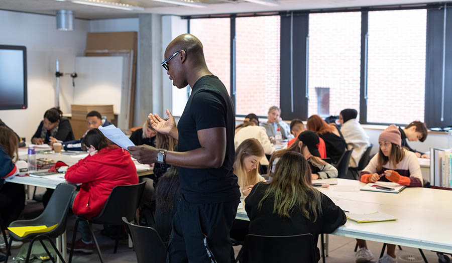 A lecturer talking to a class of students