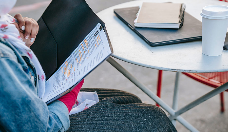 A woman reading a file of papers