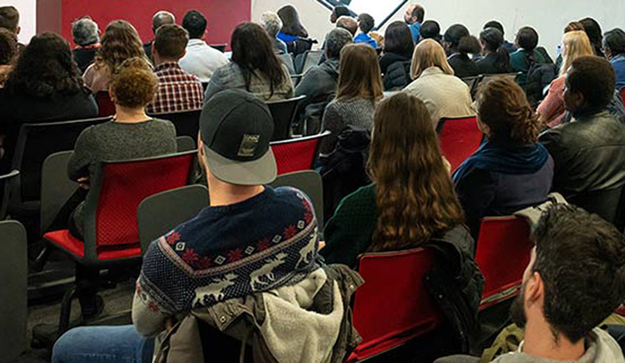 An audience seated and seen from behind