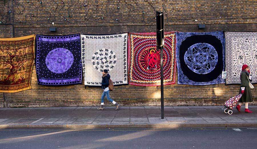 Rugs hang upwards on a street