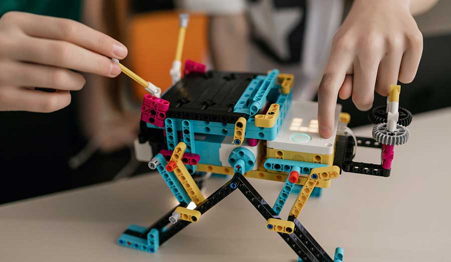 zoom in on hands of people playing with Lego blocks