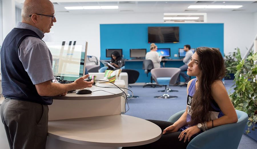 A member of staff talking to a student