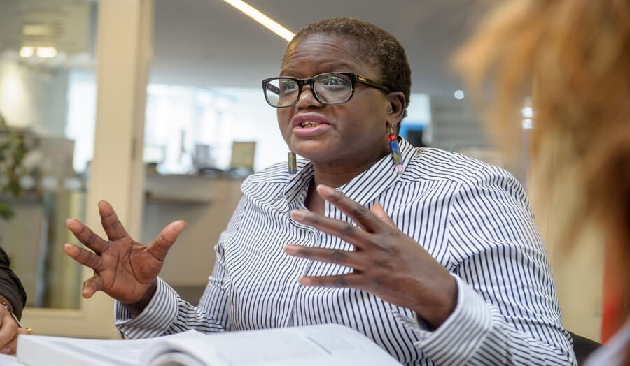 Postgraduate female student explaining things in the Piazza