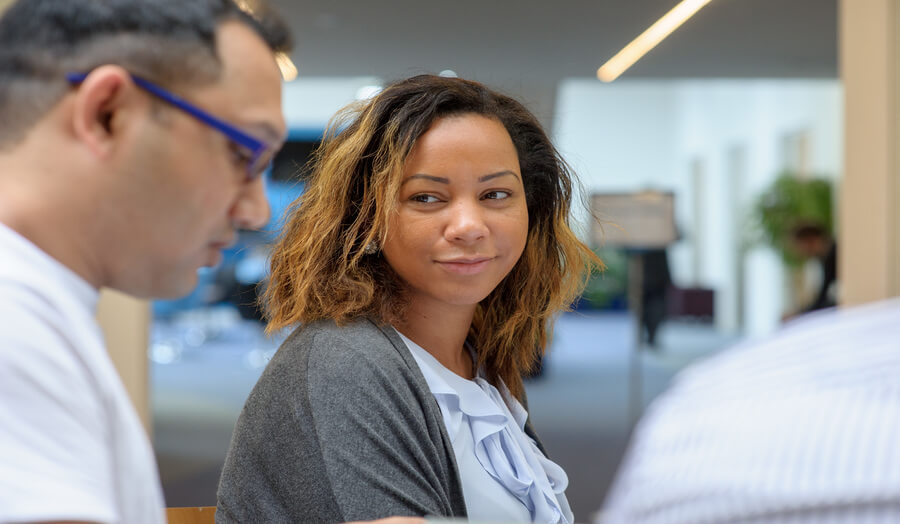 Postgraduate female student interacting with students in the Piazza
