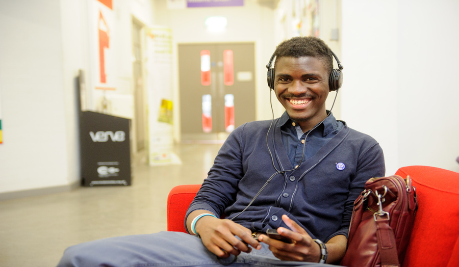 Male student sitting on a couch