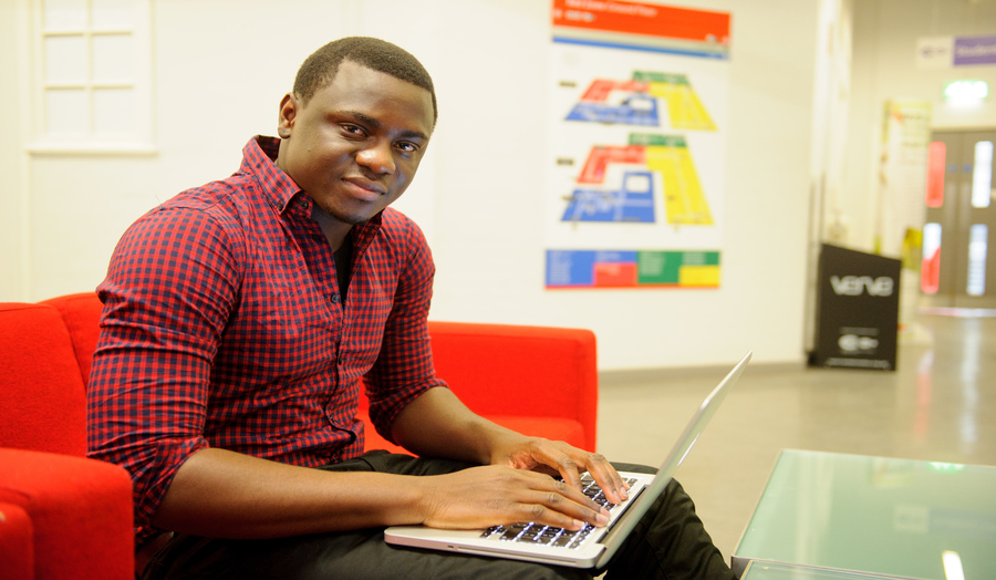 Male student working on laptop