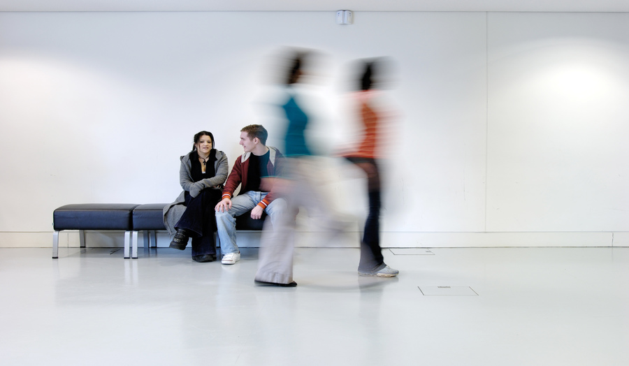 Two students sitting on a bench in the Graduate Centre