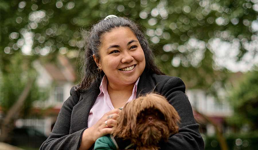 Chrystalle Margallo smiling with her dog