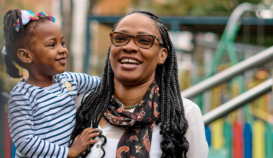 Denise pictured with one of her children, both smiling