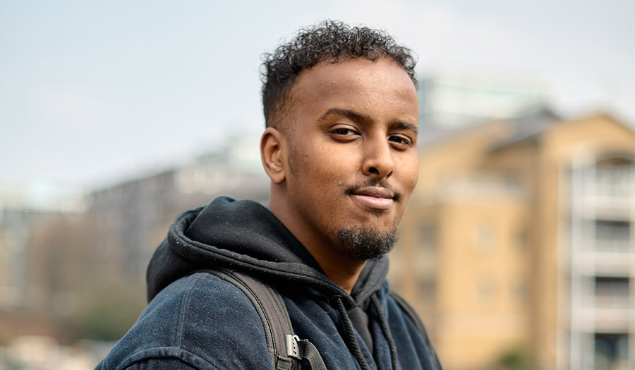 Diini with a council estate in the background