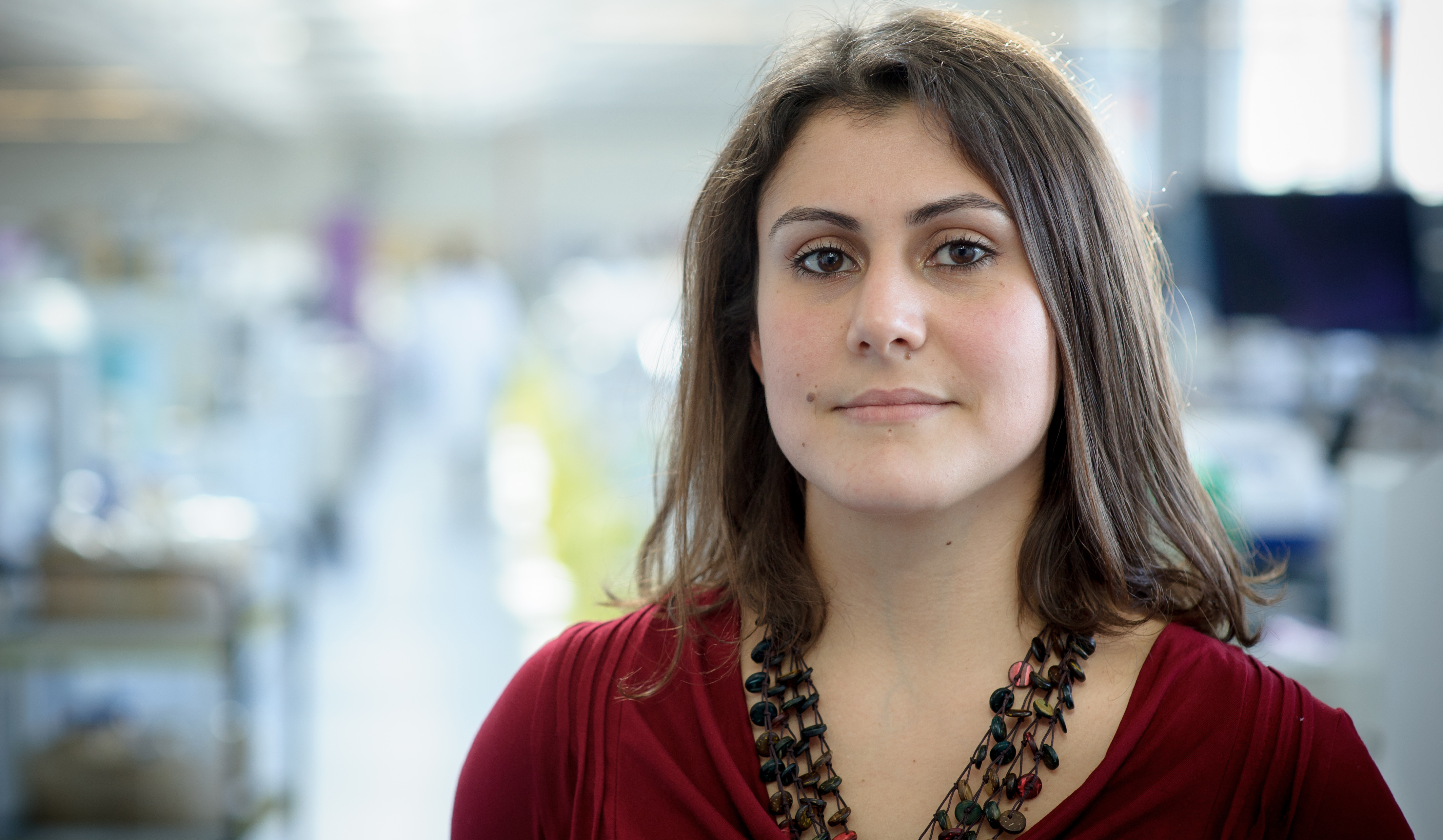 Female student in red top in science lab
